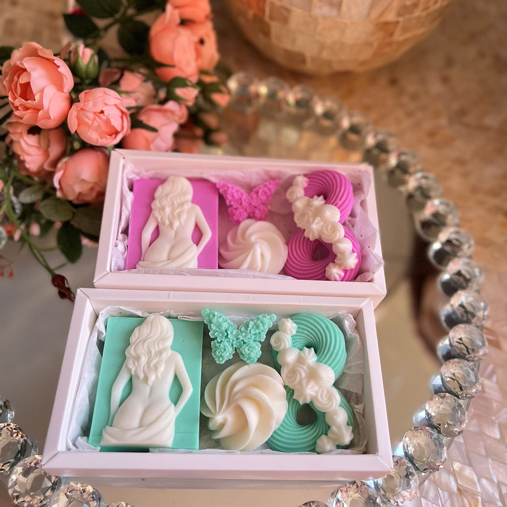Decorative box with pastel-colored soap figurines and designs on a decorative table.
