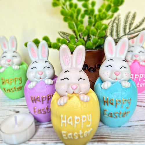 Decorative Easter eggs with bunny faces and 'Happy Easter' text, surrounded by plants.