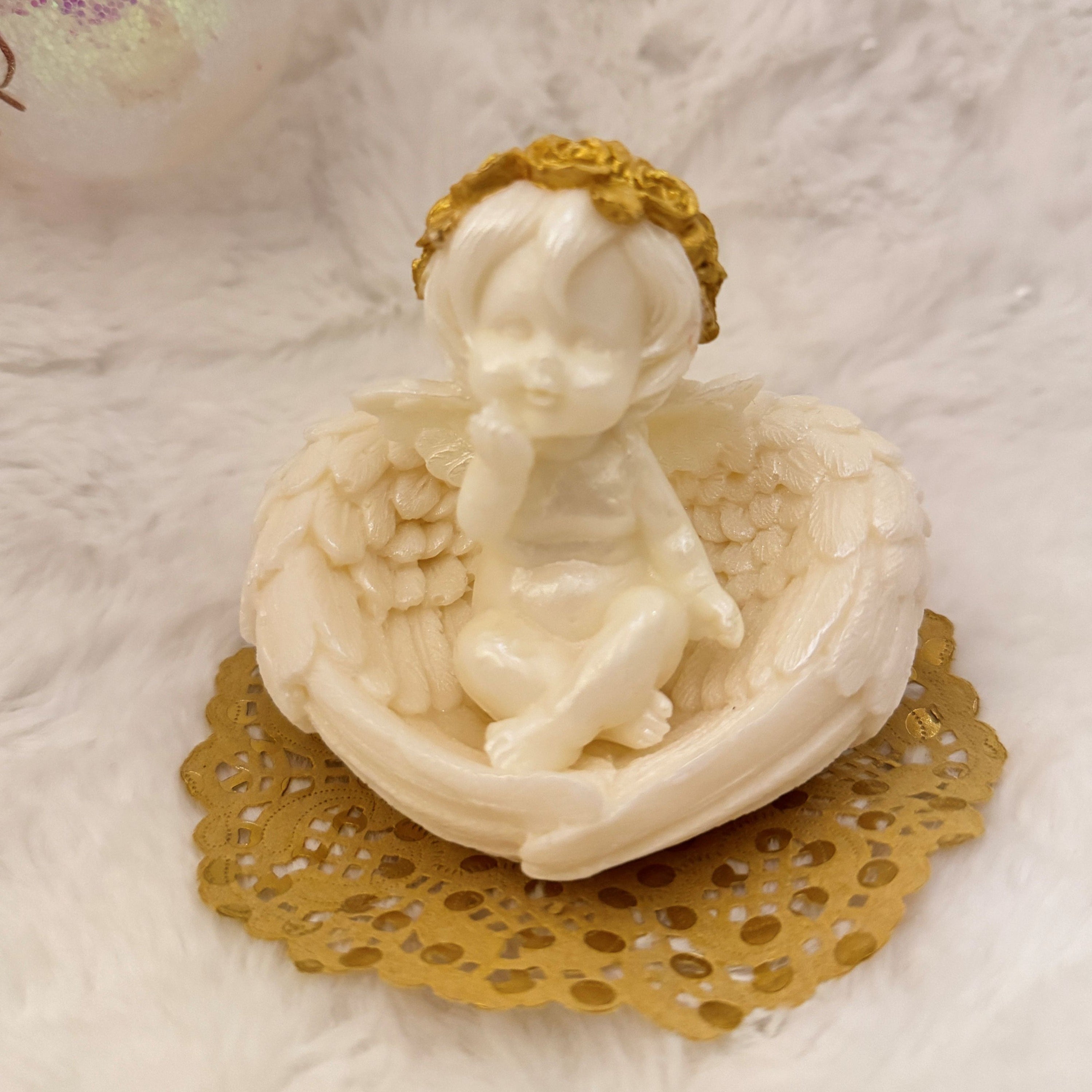 Handmade angel soap with golden halo and delicate wings sitting on gold doily, white decorative cherub soap gift