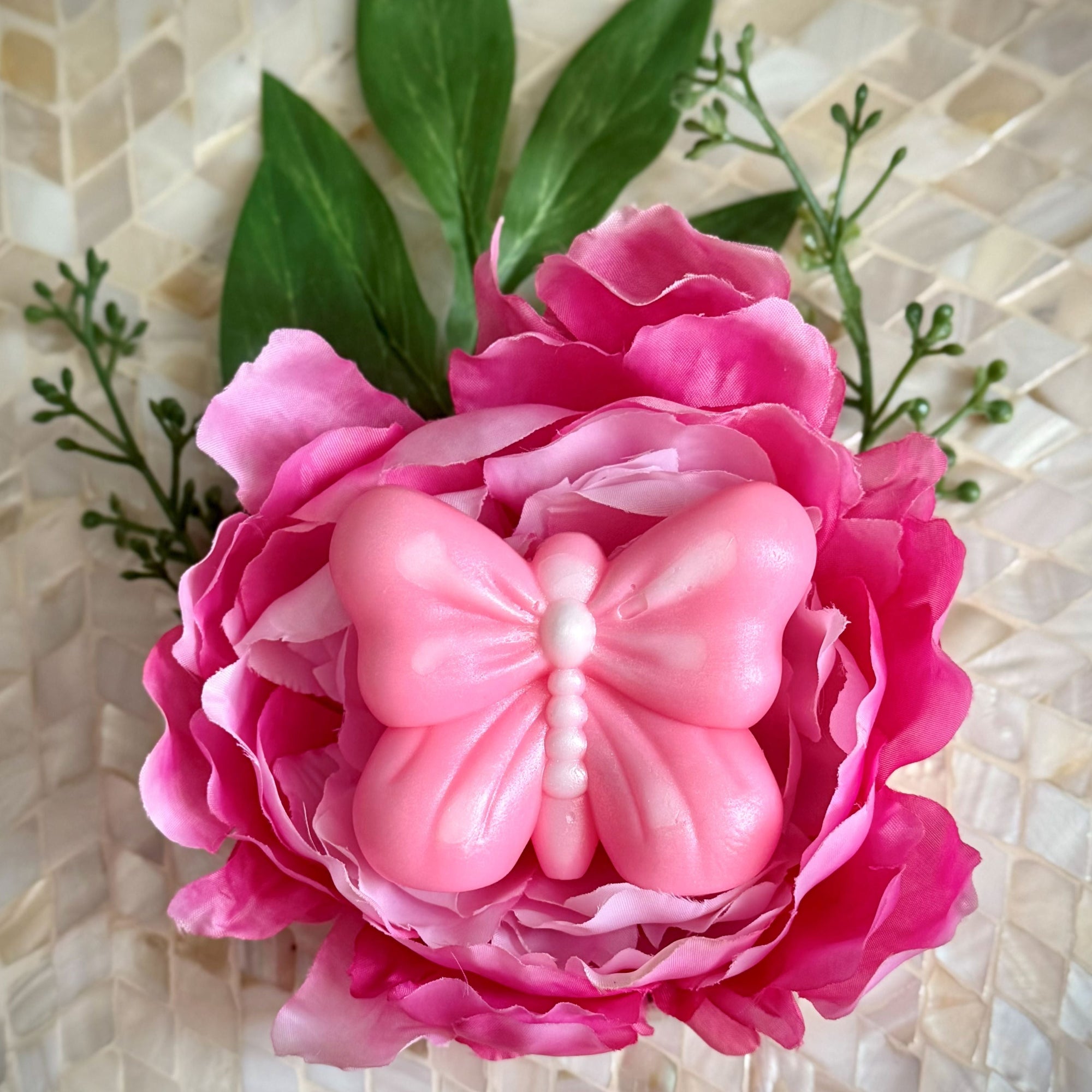 Pink flower with a butterfly on a textured beige background